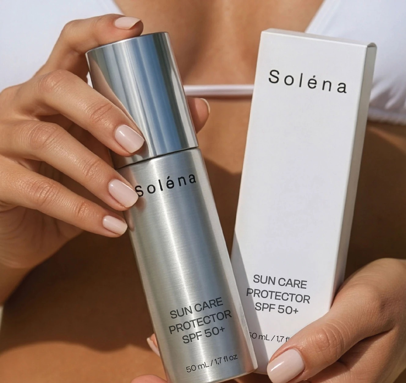 Solena sun care protector SPF 50+ bottle and box held in hands